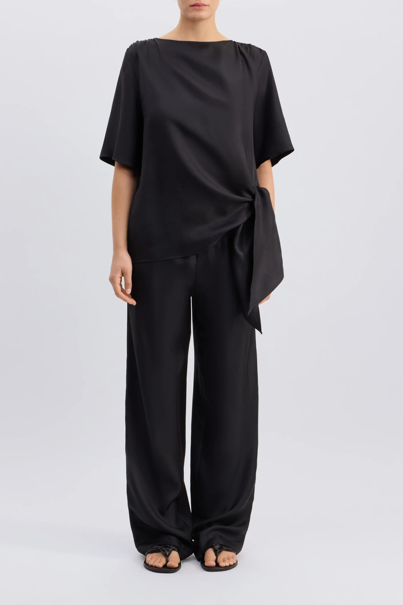front profile model wearing Mano Short Sleeve Knotted Blouse Black Straight fit
Short sleeves
Boat neck
Gathered fabric at the shoulders
Asymmetric hemline
Knotted waist detail
100% Silk Twill