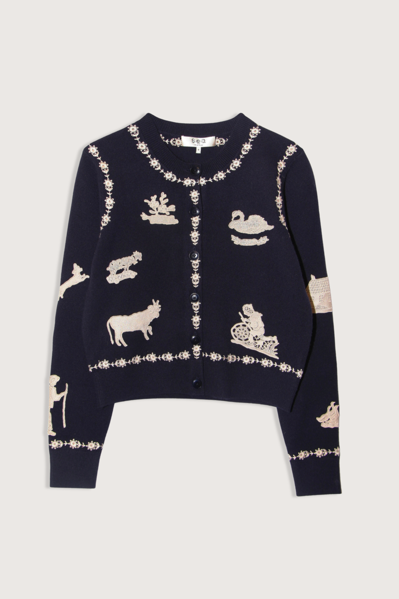 flat lay Margeurite Cardigan navy Long sleeves cardigan
Refined ribbed knit detailing throughout
Folklore-inspired lace appliqué patches
Floral embroidery
Self-100% wool
Embroidery-100% polyester
Button front
Relaxed fit