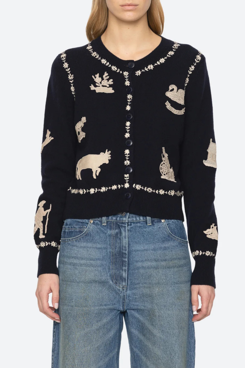 front profile model wearing Margeurite Cardigan navy Long sleeves cardigan
Refined ribbed knit detailing throughout
Folklore-inspired lace appliqué patches
Floral embroidery
Self-100% wool
Embroidery-100% polyester
Button front
Relaxed fit