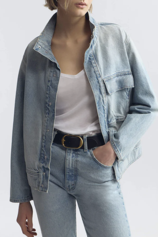 front profile model wearing Marilou Denim Jacket alice wash light blue Oversized fit
Utilitarian design
Japanese non-stretch denim cotton
Stand up collar
Snap front closure
Front chest flap pocket