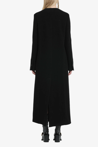 back profile model wearing Maxi Coat black long black vent Collarless
Double-breasted
Slim fit
Double-button front closure
Flap pockets on the sides