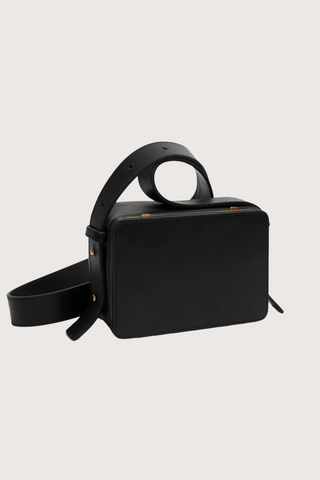 side profile of Maya cooper black Bag smooth leather exterior back pocket adjustable strap structured square shape with Stainless steel frame is 24k gold-plated