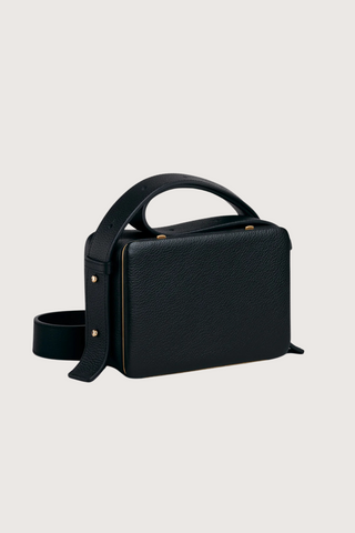 side profile of Maya Brandon Black Bag pebbled leather exterior back pocket adjustable strap structured square shape with Stainless steel frame is 24k gold-plated