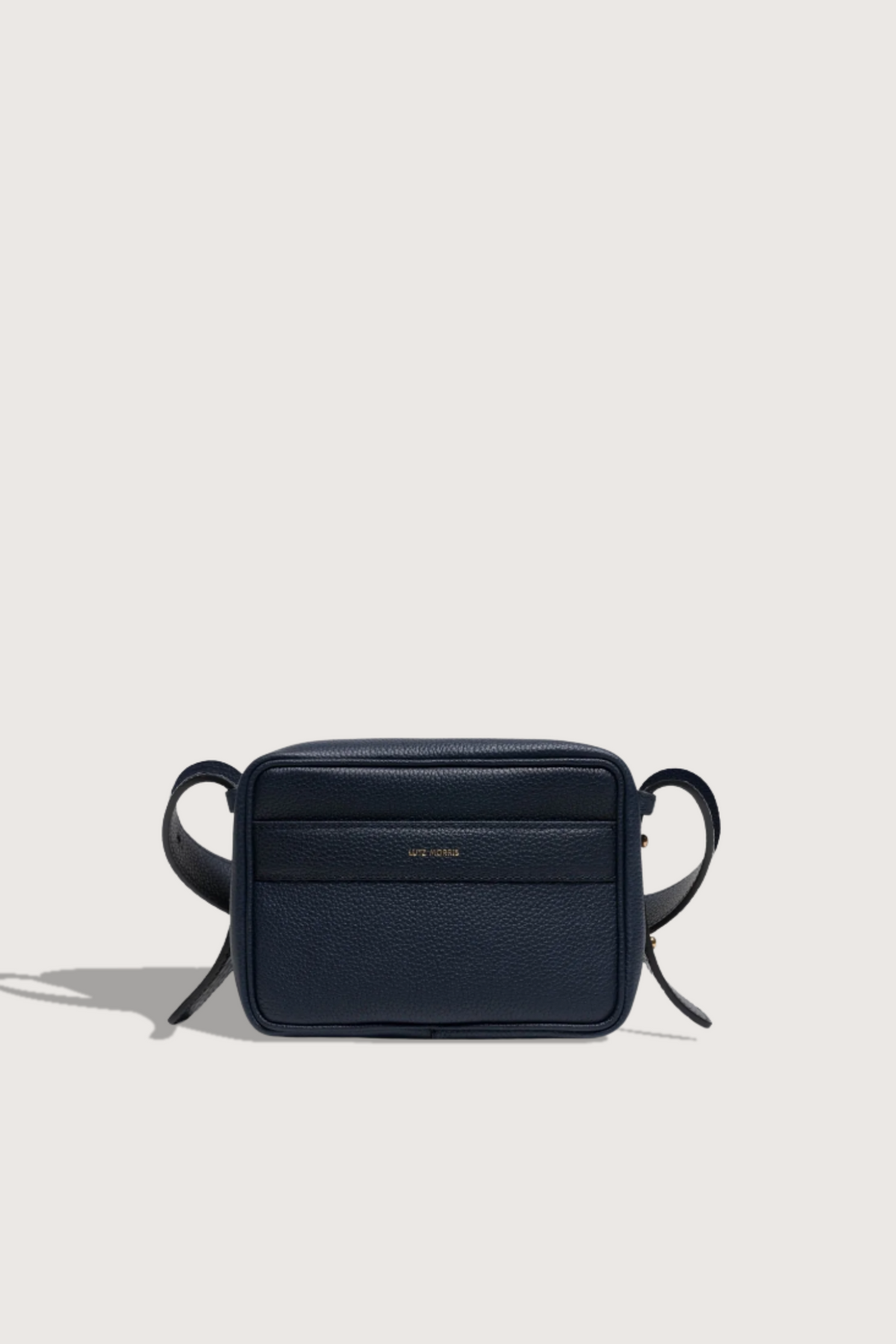 flat lay Maya Brandon Navy Bag pebbled leather exterior back pocket adjustable strap structured square shape