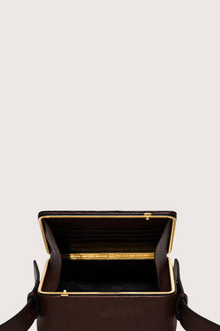 opened view of Maya cooper chocolate Bag smooth leather exterior back pocket adjustable strap structured square shape with Stainless steel frame is 24k gold-plated and seven interior card slots