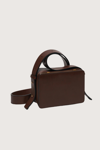 side profile of Maya cooper chocolate Bag smooth leather exterior back pocket adjustable strap structured square shape with Stainless steel frame is 24k gold-plated