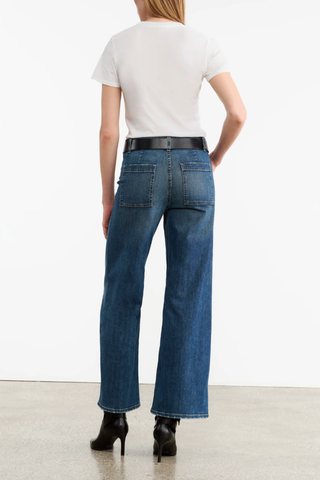 back profile model wearing Megan Jean Classic Wash mid blue Mid-rise
Wide leg jean cotton
Japanese stretch denim
Fitted through waist and hips
Cropped ankle length
Opens to a relaxed leg
No front pockets
No outer side seam
Back patch pockets
Back darts
Zip fly