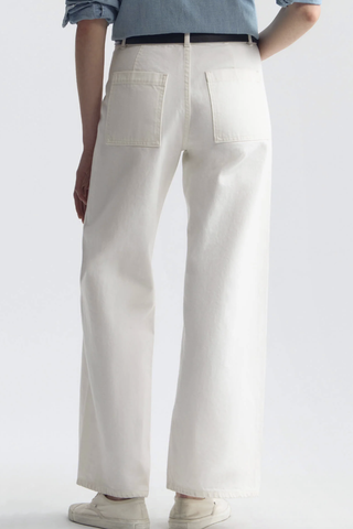 back profile model wearing Megan Jean Cream Mid-rise
Wide leg jean
Fitted through waist and hips
Cropped ankle length
Opens to a relaxed leg
No front pockets
No outer side seam
Back patch pockets
Back darts
Zip fly
Shank closure
Belt loops