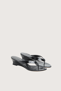 angled profile Micro Thong Wedge Sandal Black Micro Wedge Thong
Coco black croc embossed leather
Cushioned calf leather insole
40mm heel