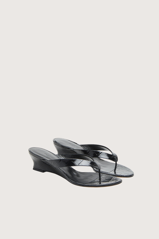 angled profile Micro Thong Wedge Sandal Black Micro Wedge Thong
Coco black croc embossed leather
Cushioned calf leather insole
40mm heel