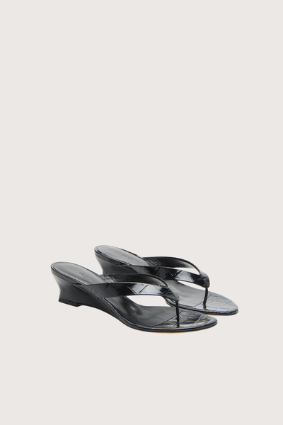 angled profile Micro Thong Wedge Sandal Black Micro Wedge Thong
Coco black croc embossed leather
Cushioned calf leather insole
40mm heel