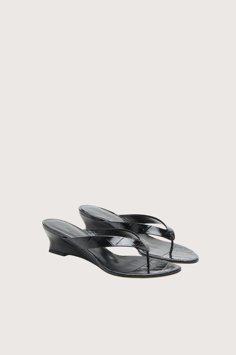 angled profile Micro Thong Wedge Sandal Black Micro Wedge Thong
Coco black croc embossed leather
Cushioned calf leather insole
40mm heel