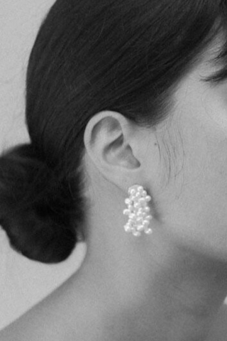 model wearing Mini Mermaid Fringed Pearl Earring Silver Clusters of irregular sea pearls
Grouped en masse for sculptural dynamism
Recycled Sterling Silver and baroque pearls strung on silk
Earring length 3.5cm