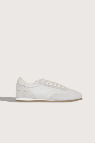 side profile Minimal Runner Sneaker white Upper: 100% Suede and Nappa Leather
Retro running style
Slim sole
Lace up
Stamped gold serial number branding on the side