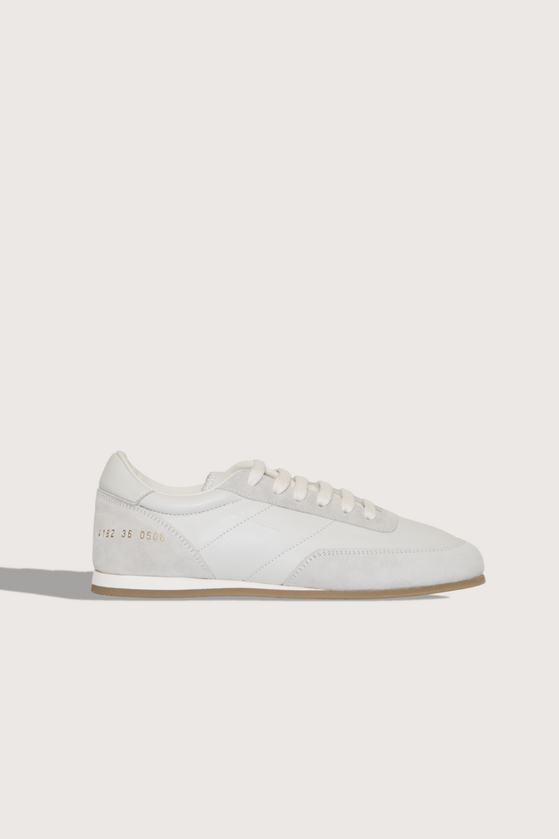 side profile Minimal Runner Sneaker white Upper: 100% Suede and Nappa Leather
Retro running style
Slim sole
Lace up
Stamped gold serial number branding on the side