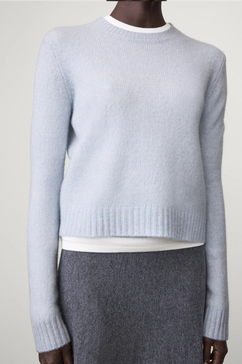 front profile model wearing Mira Long Sleeve Sweater horizon light blue cashmere regular fit cropped crewneck
