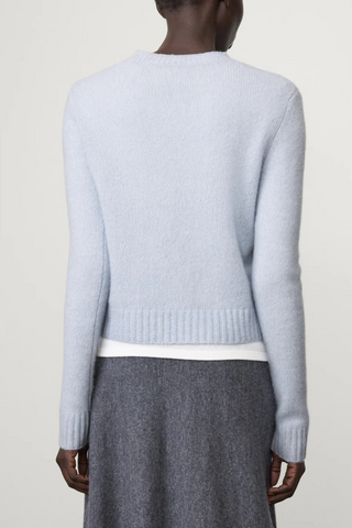 back profile model wearing Mira Long Sleeve Sweater horizon light blue cashmere regular fit cropped crewneck