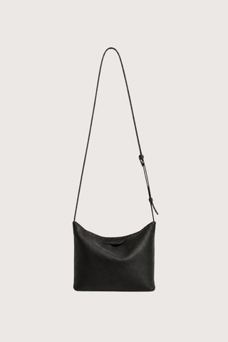 flat lay with strap expanded Moore Cross Body Bag Ink black Folded leather panel construction
Top zip closure
Two separate interior compartments
Adjustable strap is fixed on the interior
100% Calfskin Leather