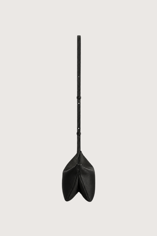 side profile with strap expanded Moore Cross Body Bag Ink black Folded leather panel construction
Top zip closure
Two separate interior compartments
Adjustable strap is fixed on the interior
100% Calfskin Leather