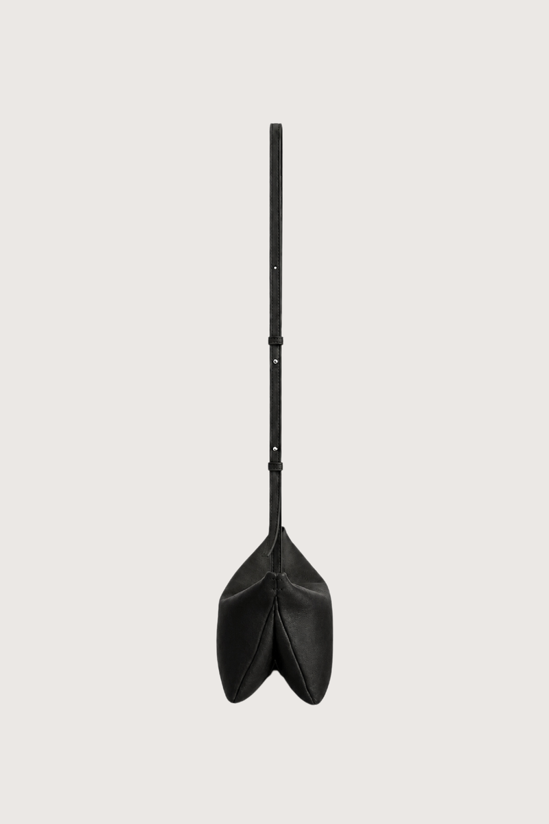 side profile with strap expanded Moore Cross Body Bag Ink black Folded leather panel construction
Top zip closure
Two separate interior compartments
Adjustable strap is fixed on the interior
100% Calfskin Leather