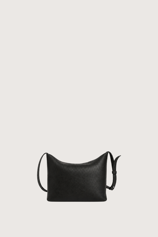 flat lay without strap expanded Moore Cross Body Bag Ink black Folded leather panel construction
Top zip closure
Two separate interior compartments
Adjustable strap is fixed on the interior
100% Calfskin Leather