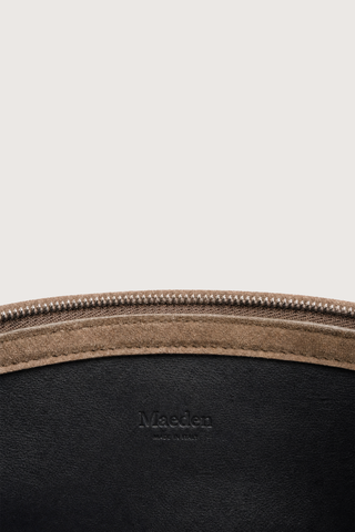inside logo and zipper detail for Moore Cross Body Bag Nubuck Contour
Folded leather panel construction
Top zip closure
Two separate interior compartments
Adjustable strap is fixed on the interior
100% Goat Nubuck Leather