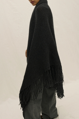 side profile model wearing Myles Shawl With Fringe charcoal grey Hand knitted
Italian cashmere blend yarn
Oversized
Long hand knotted fringe
Designed to be wrapped
Italian Yarn