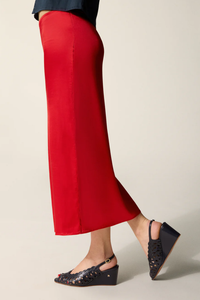 side profile model wearing Naella Satin Skirt red