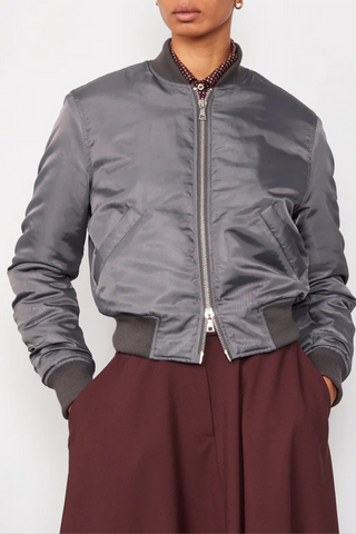 front profile model wearing Nanni Jacket anthracite grey  padded zipper closure bomber jacket style  with gathered sleeves