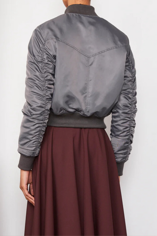 back profile model wearing Nanni Jacket anthracite grey  padded zipper closure bomber jacket style  with gathered sleeves