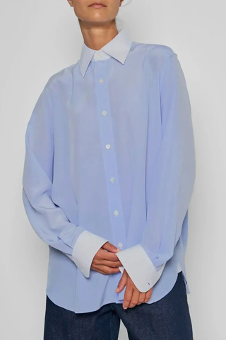 front profile model wearing New Work Shirt light blue and white Fluid silk body
Crisp white cotton poplin square collar and cuffs
Hem gussets in white poplin finish
Straight cut - classic fit
Back yoke with pleat
Mother-of-pearl buttons
Light weight fabric
90% silk crepe de chine/10% cotton poplin