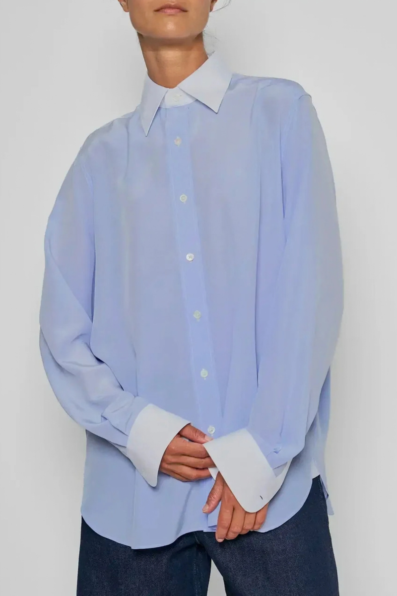 front profile model wearing New Work Shirt light blue and white Fluid silk body
Crisp white cotton poplin square collar and cuffs
Hem gussets in white poplin finish
Straight cut - classic fit
Back yoke with pleat
Mother-of-pearl buttons
Light weight fabric
90% silk crepe de chine/10% cotton poplin