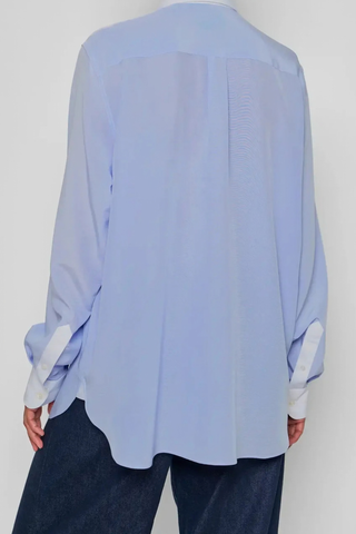 back profile model wearing New Work Shirt light blue and white Fluid silk body
Crisp white cotton poplin square collar and cuffs
Hem gussets in white poplin finish
Straight cut - classic fit
Back yoke with pleat
Mother-of-pearl buttons
Light weight fabric
90% silk crepe de chine/10% cotton poplin