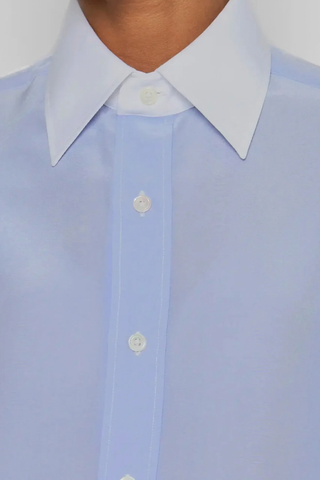 close up collar detail for New Work Shirt light blue and white Fluid silk body
Crisp white cotton poplin square collar and cuffs
Hem gussets in white poplin finish
Straight cut - classic fit
Back yoke with pleat
Mother-of-pearl buttons
Light weight fabric
90% silk crepe de chine/10% cotton poplin