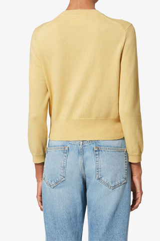 back profile model wearing  Newton Iconic Cardigan Light Yellow Cotton cardigan with long sleeves
Round neck
Button closure
Marant logo
70% Cotton, 30% Laine Wool