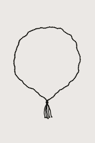 flat lay Noir Tassel Necklace black  Round black onyx beads
Softly draped tassel
Can be worn long or layered to add contrast and texture to everyday dressing
Necklace length 80cm. Tassel length 10cm