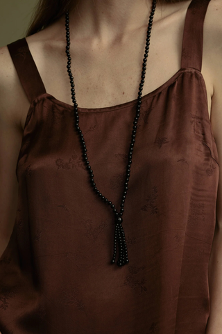 model wearing Noir Tassel Necklace black  Round black onyx beads
Softly draped tassel
Can be worn long or layered to add contrast and texture to everyday dressing
Necklace length 80cm. Tassel length 10cm