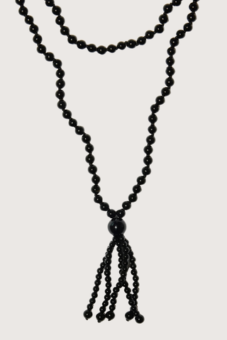 close up beads detail for Noir Tassel Necklace black  Round black onyx beads
Softly draped tassel
Can be worn long or layered to add contrast and texture to everyday dressing
Necklace length 80cm. Tassel length 10cm