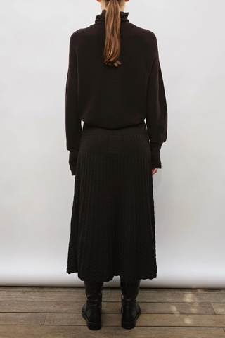 back profile model wearing Nora Oversized High Neck Knit Top Ebony dark brown
Drapes loosely around the neck
Loose fit
Long sleeves
Garter-stitch knit sweater
Wide slit cuffs
100% pure extra-soft virgin wool
