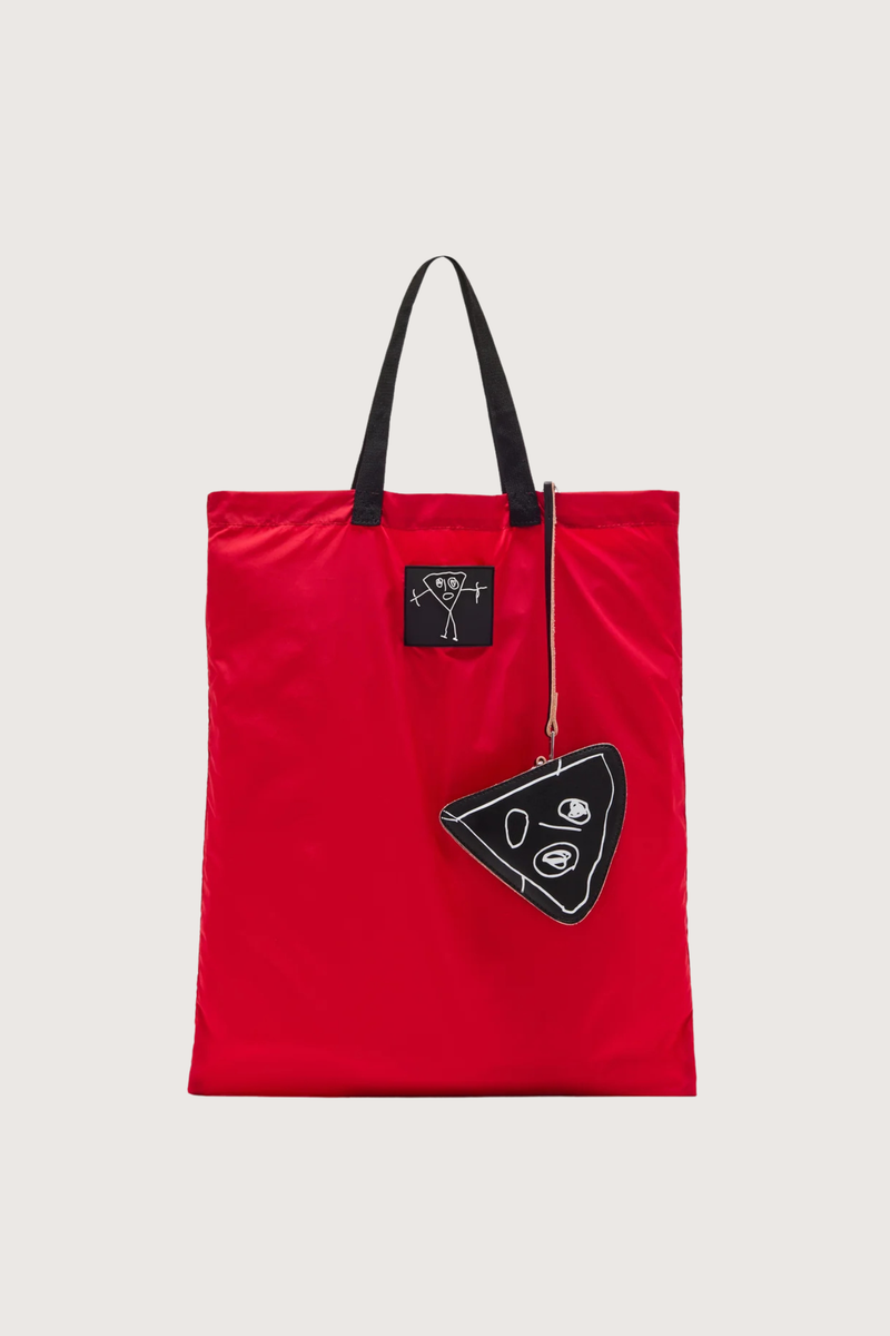 flat lay front  profile Nylon Bag red with black strap and logo patch Foldable nylon tote
Leather triangle pouch included
99% nylon 99% domesticated bovine leather 1% metal 1% meta