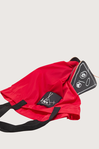 folded detail close up of Nylon Bag red with black strap and logo patch Foldable nylon tote
Leather triangle pouch included
99% nylon 99% domesticated bovine leather 1% metal 1% meta
