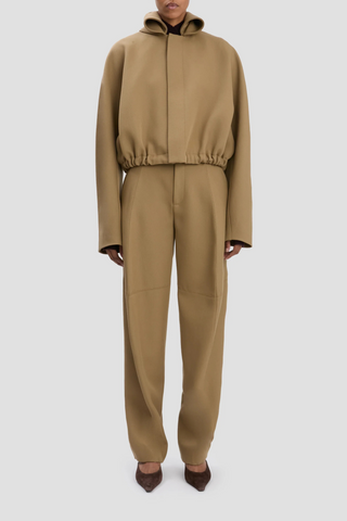 front profile model wearing Oversized Roll Neck Bomber Jacket In Dark Camel oversized fit virgin wool elastic waist