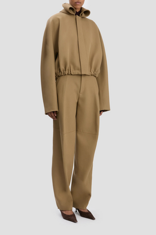 side profile model wearing Oversized Roll Neck Bomber Jacket In Dark Camel oversized fit virgin wool elastic waist