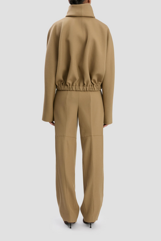 back profile model wearing Oversized Roll Neck Bomber Jacket In Dark Camel oversized fit virgin wool elastic waist