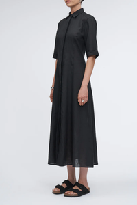 side profile model wearing Panel Shirt Dress in Black linen