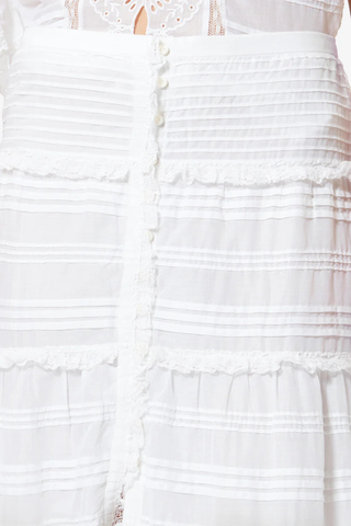 close up detail of Paoline Skirt white Long lace and organic cotton skirt
Elastic waist
Button tab
Pintucks and broderie anglaise
Flared cut
100% cotton