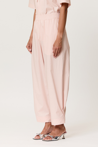 side profile model wearing Parachute Trouser With Side Detail baby pink cotton Light pink technical trousers
Smocked elastic waistband
Relaxed, tapered silhouette