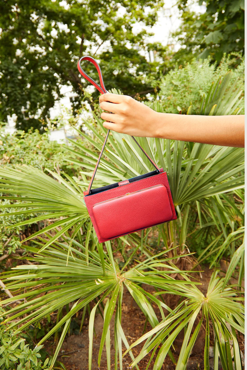 model wearing Parker Brandon Horizon leather bag Short Strap red Strap length is adjustable
Outside pocket in signature frame construction with single latch closure. gold logo embossed in back