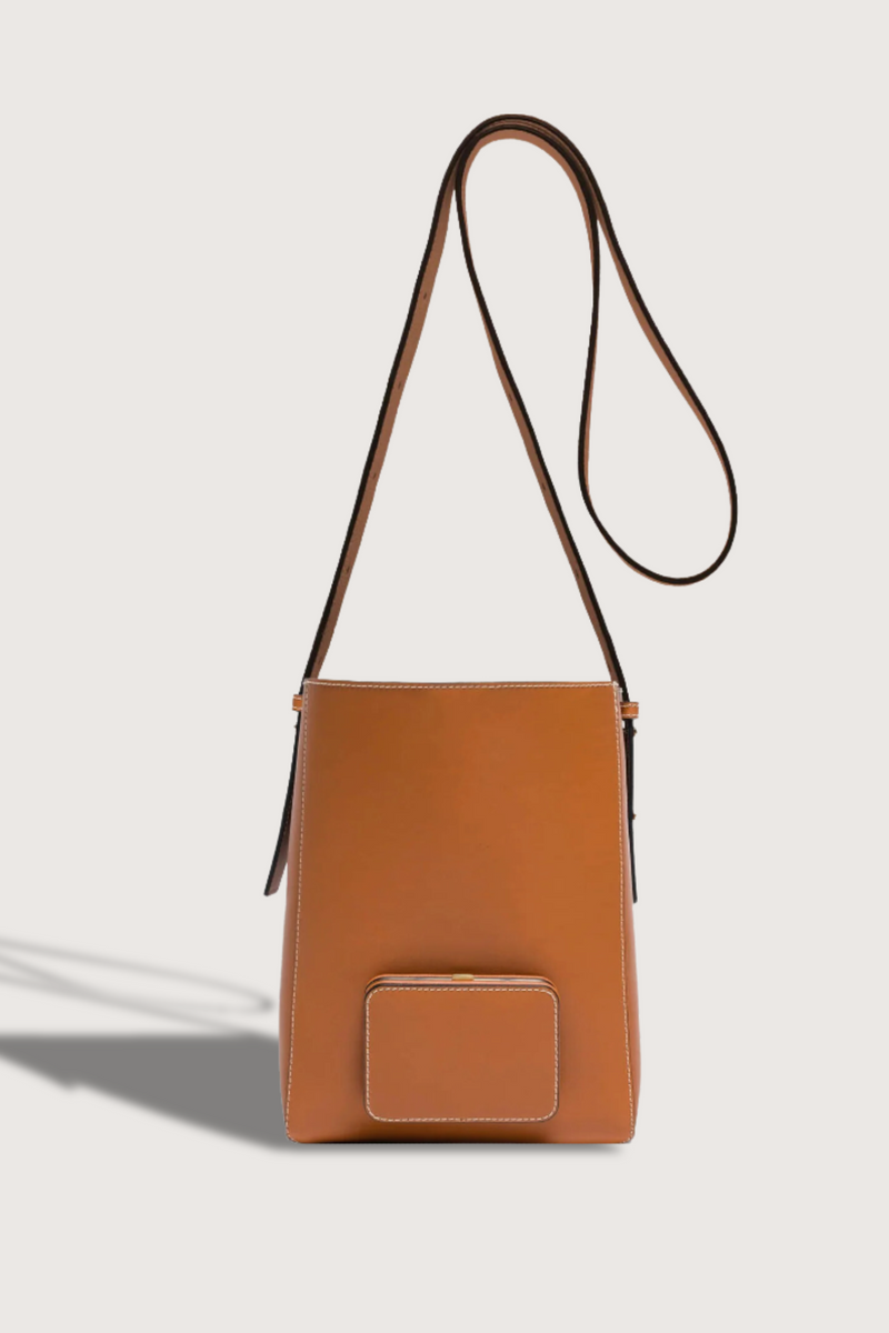 flat lay Parker M Soft Long Strap leather Tan bag with adjustable strap and exterior pocket
