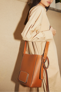 model wearing Parker M Soft Long Strap leather Tan bag with adjustable strap and exterior pocket